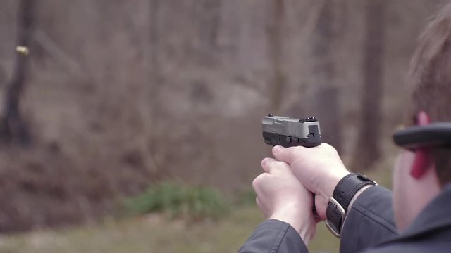 9mm handgun pistol shooting. Rapid fire in slow motion.
