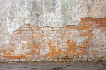 Industrial background, empty grunge urban street with warehouse brick wall. Background of old vintage dirty brick wall with peeling plaster, texture