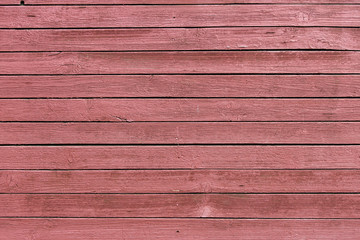 texture of a wooden fence painted in red paint