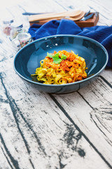 Cooked pasta with peeled shrimp, coconut milk sauce and broccoli