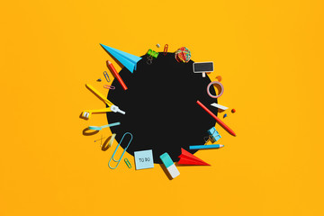 Creative flat lay with school supplies around coy space. Top view.