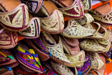 Middle eastern handmade shoes at the market display in Dubai. Gold souk