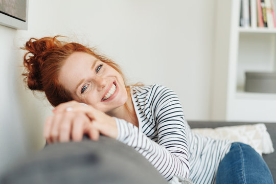 Cute young redhead woman with a vivacious smile