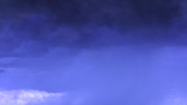 Cinematic storm clouds with lightning strikes reflecting 