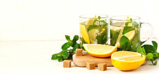 Cup of mint tea withlemon on wooden background