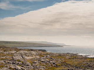 Landscape in county Clare, Burren national park, West coast of Ireland, Atlantic ocean, Cloudy sky. Famous rock surface. Sunny day.