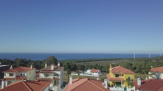 Morning aerial footage of a Portuguese neighborhood Sitio in Nazar&eacute;, Portugal with a view to the sea.