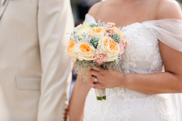 Happy wedding couple, bride holding bouquet of flowers in hand