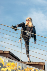 woman acrobat posing with urban clothes
