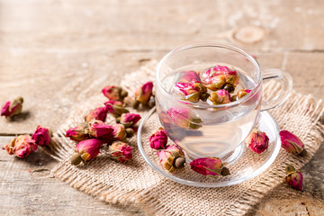 Herb tea with tea rose petals. Dry rose buds, tea cup