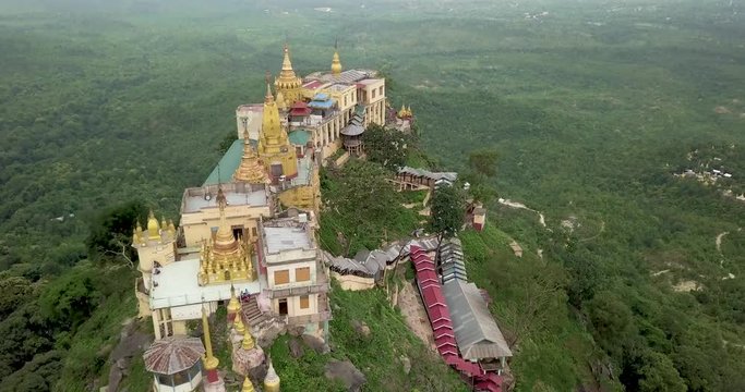 Aerial flyby shot of ancient temple on top of Mount Popa, Myanmar (Burma)