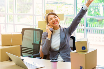 Employees in parcel delivery companies are doing computer work at an office online.