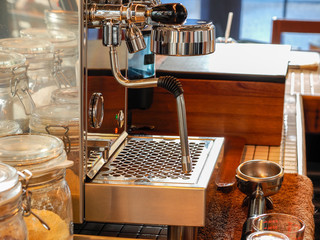 Fototapeta na wymiar Coffee machine making an espresso coffee in old style coffee shop, coffee business concept