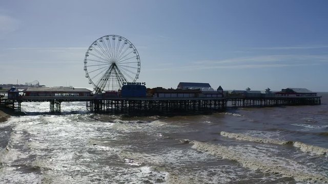 Stunning aerial view of the famous Blackpool pier at high tide, by the award winning Blackpool beach, A very popular seaside tourist location in England , United Kingdom, UK