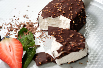 chocolate butter ice cream popsicles on the white plate with fresh summer berries, strawberries, blueberries