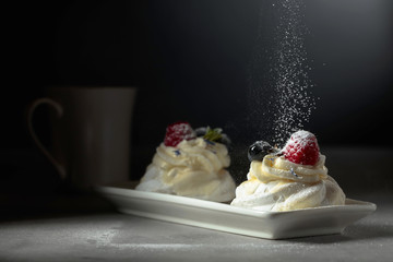 Dessert Pavlova  sprinkled with powdered sugar.