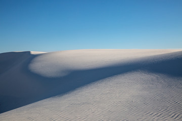 Fototapeta na wymiar Evening Shadows on the gypsum sand dunes, in White Sands National Monument, New Mexico