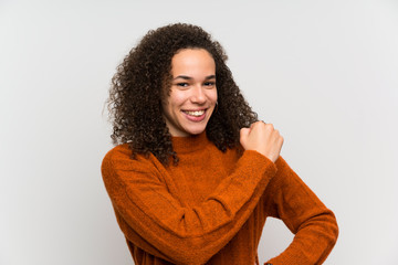 Dominican woman over isolated white wall celebrating a victory