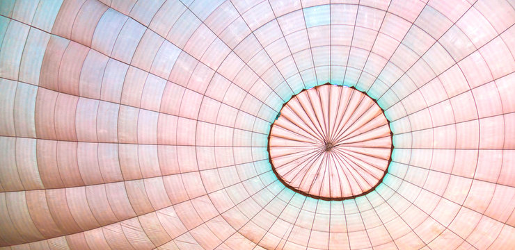 Hot air balloon's dome inside while it filling with air. Soft pastel colors.