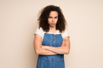 Dominican woman with overalls feeling upset