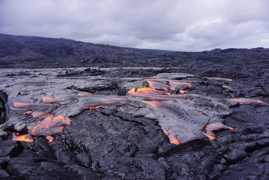 Lava field with new hot flowing lava in Big Island in Hawaii