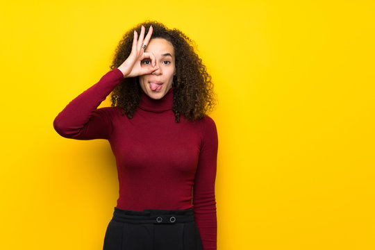 Dominican Woman With Turtleneck Sweater Makes Funny And Crazy Face Emotion