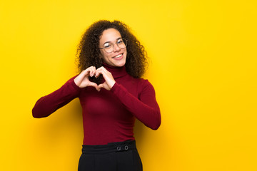 Dominican woman with turtleneck sweater making heart symbol by hands