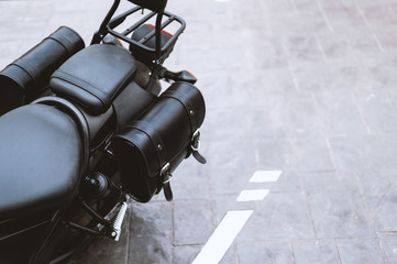 closeup of a black leather bag in motorcycle touring with soft-focus and over light in the...