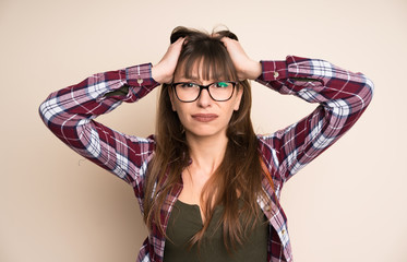 Young woman on ocher background with surprise facial expression