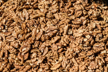 Large group of fresh walnut kernels sold at a spice food market, organic food background