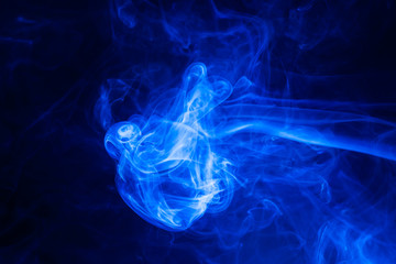 Fototapeta na wymiar Blue smoke on black background.