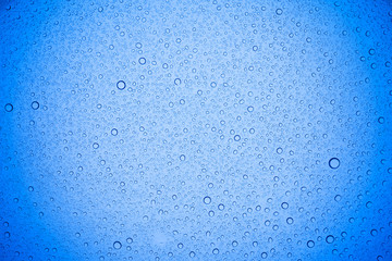 Rain droplets on blue glass background, Water drops on blue glass.