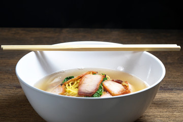 Red pork noodles ,bowl of noodles with vegetables