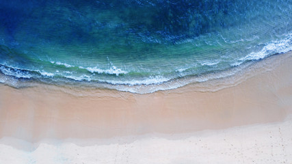 Fototapeta na wymiar Aerial top view, Beach with shade emerald blue water and wave foam on tropical sea