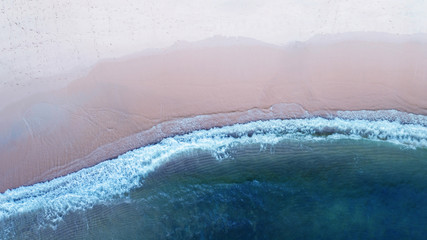 Aerial top view, Beach with shade emerald blue water and wave foam on tropical sea