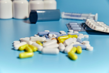 group of various medications on a blue background