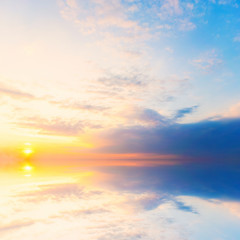 Naklejka na ściany i meble Background sky during sunset and water reflections.