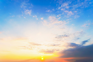 Obraz premium Sky blue and orange light of the sun through the clouds in the sky