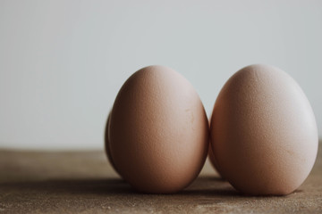 Fresh farm eggs on a wooden rustic background. Candid style on Easter