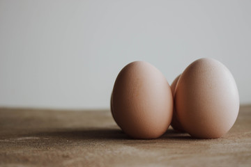 Fresh farm eggs on a wooden rustic background. Candid style on Easter