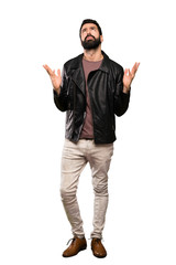 Handsome man with beard frustrated by a bad situation over isolated white background