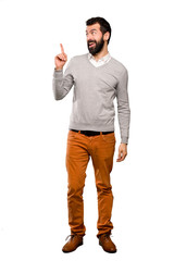 Fototapeta premium Handsome man intending to realizes the solution while lifting a finger up over isolated white background