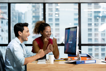 New generation businessmen feeling happy in front of computer in  office. Since online sales system...