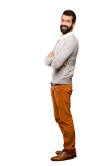 Fototapeta premium Handsome man with arms crossed and looking forward over isolated white background