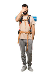 Hiker man covering eyes by hands. Do not want to see something over isolated white background