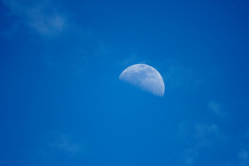 Daytime moon and clouds