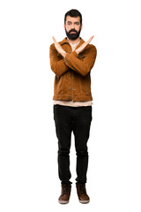 Handsome man with beard making NO gesture over isolated white background