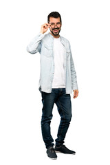 Full-length shot of Handsome man with beard with glasses and surprised over isolated white background