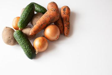Unwashed vegetables on white table
