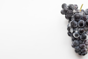 frozen grapes on a white table